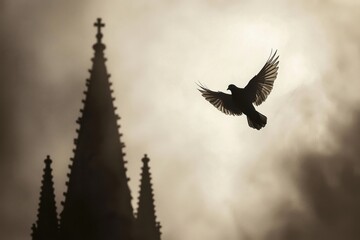 Fototapeta premium A silhouette of a dove flying against a dark cloudy sky, with a church spire in the background, symbolizing peace and spirituality.