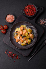 Baked salmon pieces with potatoes, cheese and olives