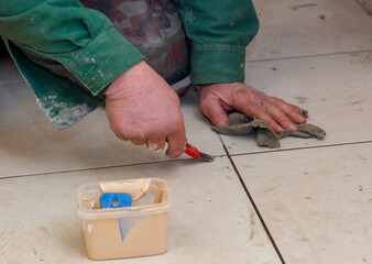 A man is kneeling on the floor