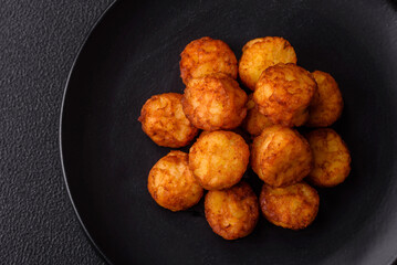 Delicious fried potato balls or croquettes with salt, spices and herbs