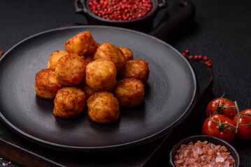 Delicious fried potato balls or croquettes with salt, spices and herbs