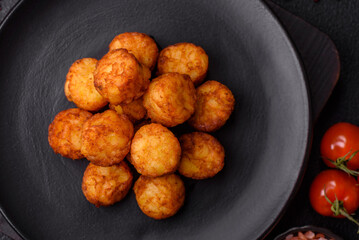 Delicious fried potato balls or croquettes with salt, spices and herbs