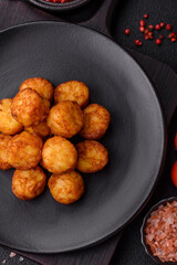 Delicious fried potato balls or croquettes with salt, spices and herbs