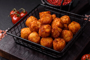 Delicious fried potato balls or croquettes with salt, spices and herbs