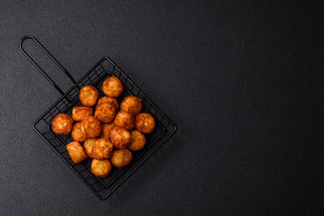Delicious fried potato balls or croquettes with salt, spices and herbs