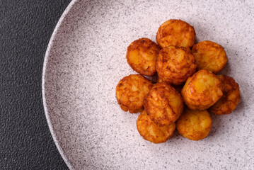 Delicious fried potato balls or croquettes with salt, spices and herbs