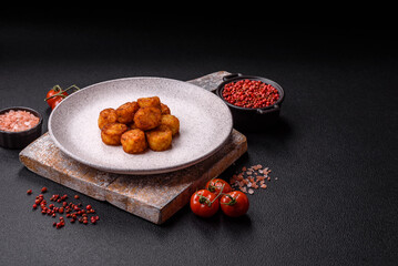 Delicious fried potato balls or croquettes with salt, spices and herbs
