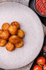 Delicious fried potato balls or croquettes with salt, spices and herbs