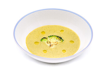 Healthy broccoli soup with a slice of grilled broccoli on a white porcelain plate