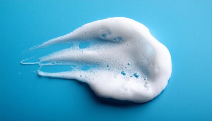 White skincare cleansing foam on light blue background