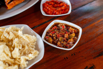 sambal dadak, a traditional spicy sauce from sundanese heritage, indonesia, made freshly grinded chili, garlic, and red onion, served on small bowl