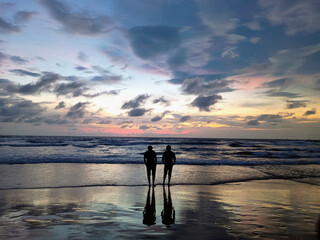 silhouette of persons on the beach