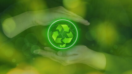 Hand holding earth with a recycling symbol is made of used plastic bottles. ecological waste management and a sustainable and environmental sustainability. Eco friendly