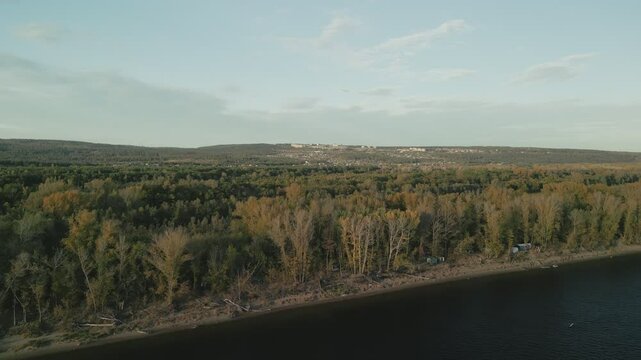 Autumn landscape showing river and forest next to a small town