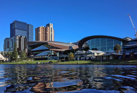 Adelaide, South Australia, Australia - December 11 2024: Adelaide Convention Centre, on North Terrace, seen across the river Lake Torrens. Low angle view. Copy space in water.