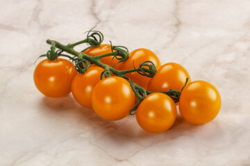 Yellow sweet tomato on the branch