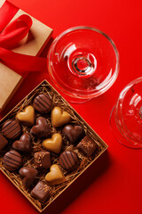 A glasses of champagne elegantly paired with a box of rich chocolates