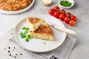 Spanish omelette tortilla with potatoes and onion on a stone background. Spanish cuisine. Top view.