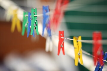 Colored clothespins hanging on a rope