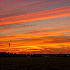 Obraz premium Sunset over sea beach area field with colorful aesthetic sky clouds