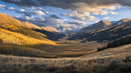 Fototapeta premium Autumn mountain valley vista, golden aspens, dramatic sky, scenic backdrop