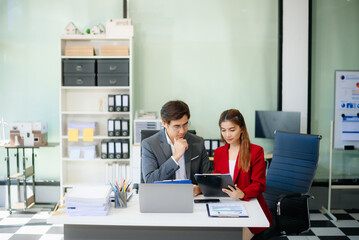 Happy businesspeople while collaborating on a new project in an office.