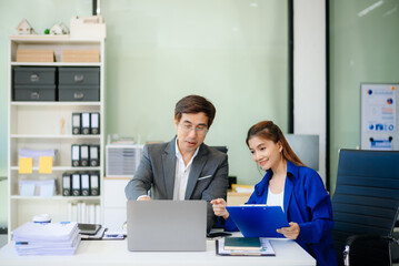 Happy businesspeople while collaborating on a new project in an office.