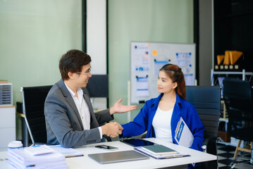 business people shaking hands during a meeting in office.