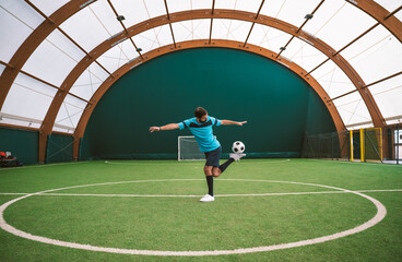 Cinematic image of a soccer freestyle player making tricks with the ball.