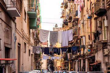 city view of old down town street of slum area with vintage facades of buildings and drying clothes...