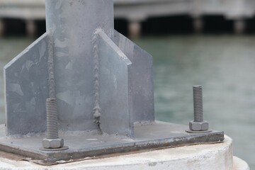 Nuts fasten the steel pole structure.