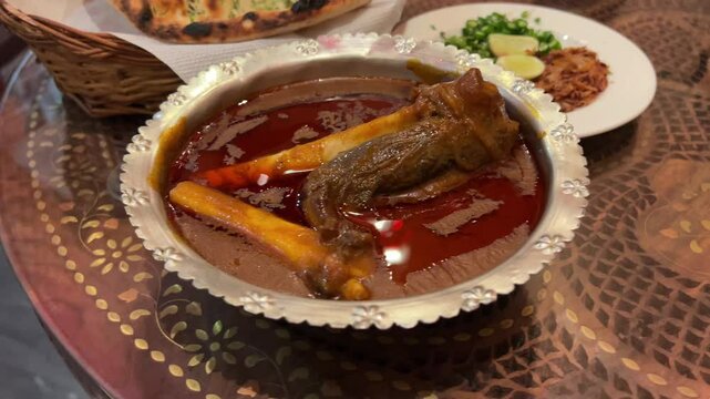 Closeup footage featuring mutton Nalli Nihari prepared in Indian style dipped in oily gravy.