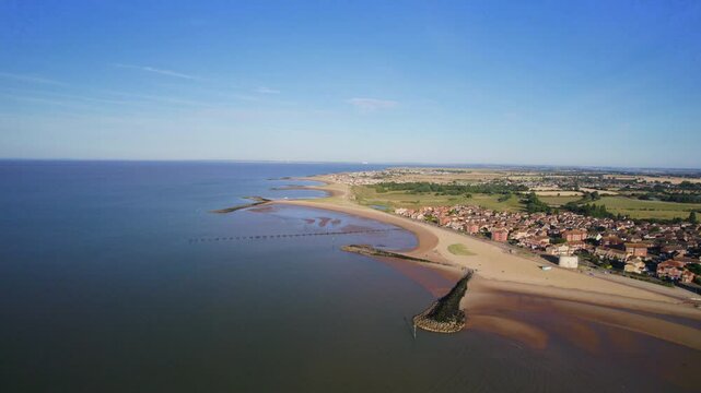 Aerial shot flying along Essex coastline near Jaywick at dawn