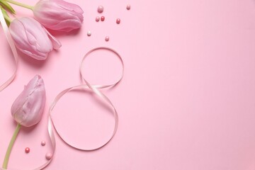 Beautiful bouquet of tulip flowers and eight made of ribbon on colored background