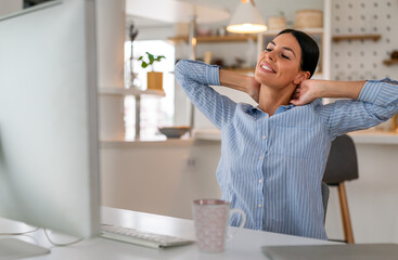 Beautiful young concentrated business woman wearing shirt using laptop in modern workspace