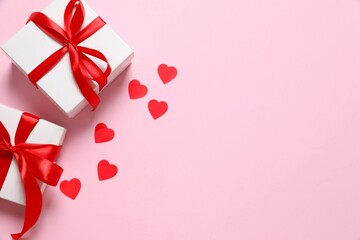 Gift boxes with red hearts on color  background