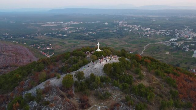 White cross on a mountain, aerial view. Mount Križevac pilgrimage site near the tourist town of Medjugorje.