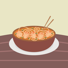 ramen noodles with soup and chopsticks in a bowl and on a table