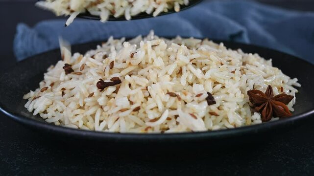 Serving jeera rice in a plate.