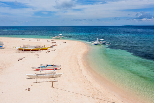 Wooden boats at the beach, Pamilacan island, Philippines