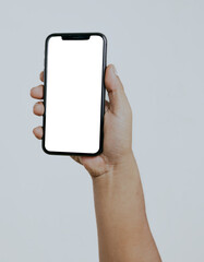 Hand holding blank white screen smartphone isolated on white background. Copy space for text.