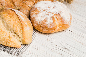 Homemade natural breads. Different kinds of fresh bread as background, perspective view with copy space