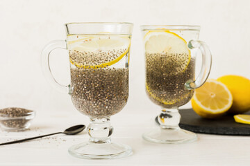 Healthy breakfast or morning with chia seeds and lemon on table background, vegetarian food, diet and health concept. Chia pudding with lemon