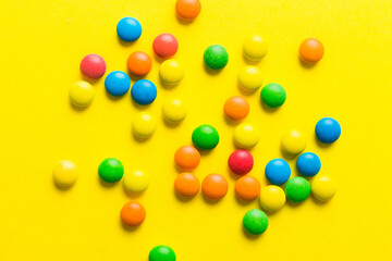 Mixed collection of colorful candy, on colored background. Flat lay, top view. frame of colorful chocolate coated candy