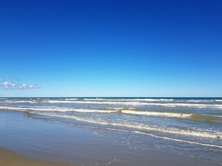 beautiful sandy beach and blue sky with clouds, nice summer background