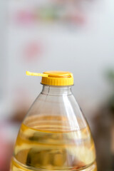Yellow plastic cap for PET bottle with sunflower oil. New design with less plastic, the cap remains attached to the bottle after opening. Designed to reduce plastic waste.