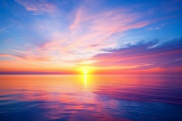 Fototapeta premium Dramatic sunset features orange and purple clouds blending into a deep blue sky, mirrored perfectly on a tranquil lake during a peaceful evening