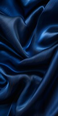 Obraz premium Blue wavy smooth shiny silk fabric texture luxurious background with copy space