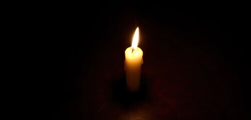 Lit Candle in the Dark Wallpaper Background