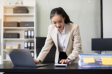 businesswoman analyzing stats and graphs on paperwork outside a modern office building. Ideal for themes of success, analysis, and corporate growth.